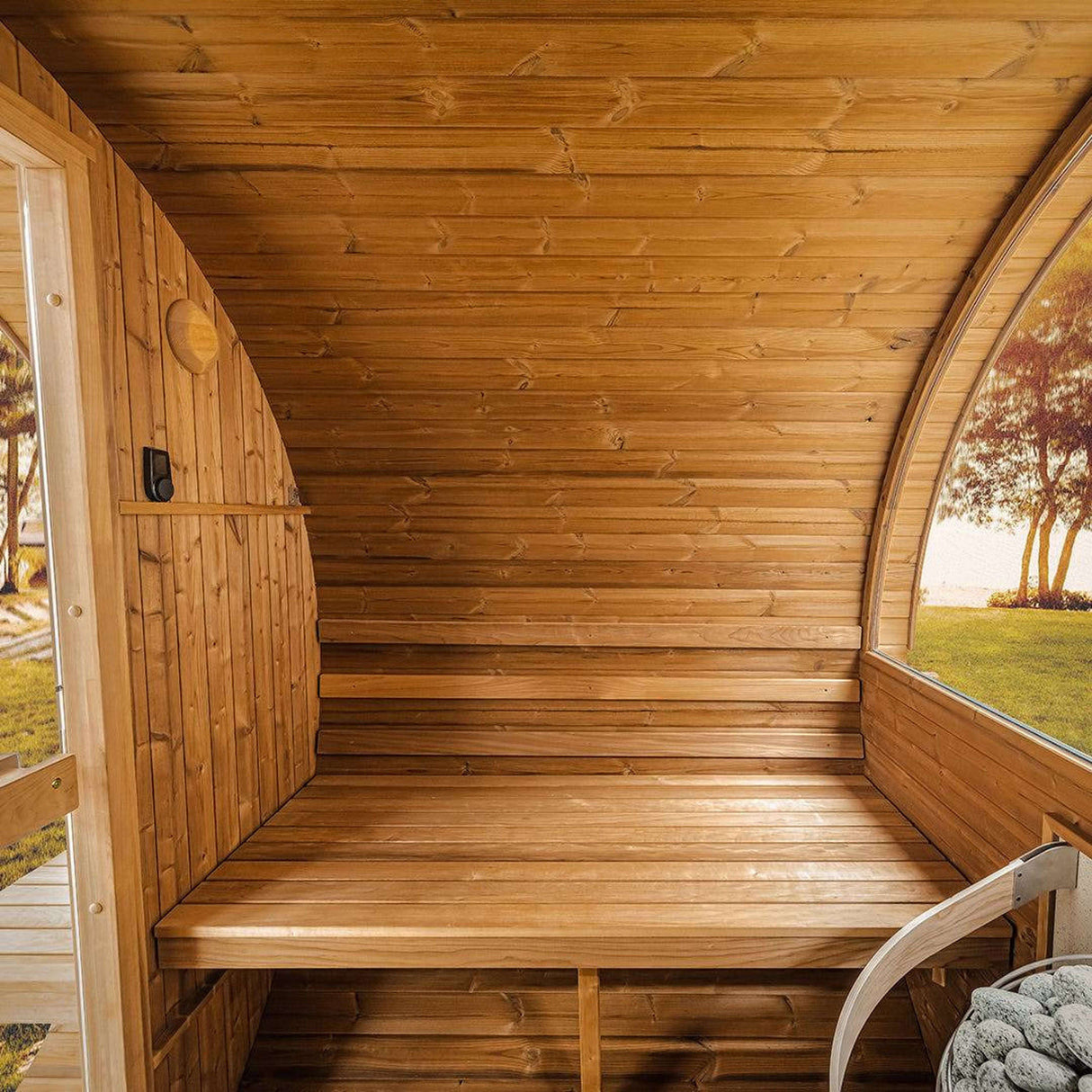 Side bench view inside Thermory Barrel Sauna Model #60 DIY Kit with curved wood walls. Comfortable seating for 4-person sauna experience.