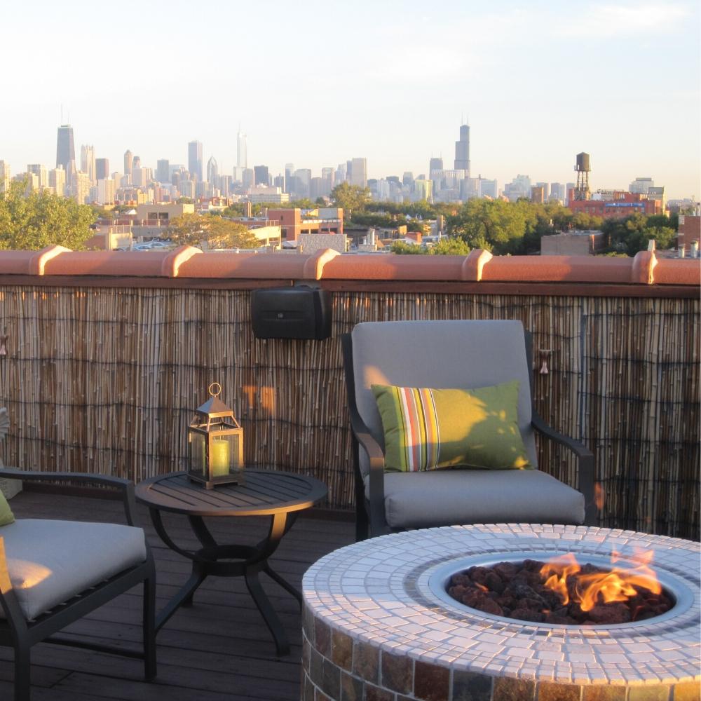 Rooftop patio with Firegear DIY Fire Pit Kit - Round tiled fire pit, offering skyline views and a cozy urban outdoor space.