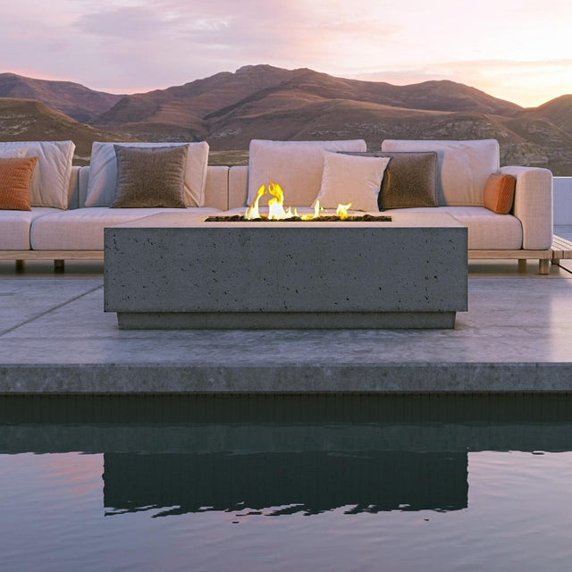 Firegear Sanctuary Rectangular Concrete Gas Fire Pit Table in Slate finish, poolside setup with sunset view and cozy seating area.