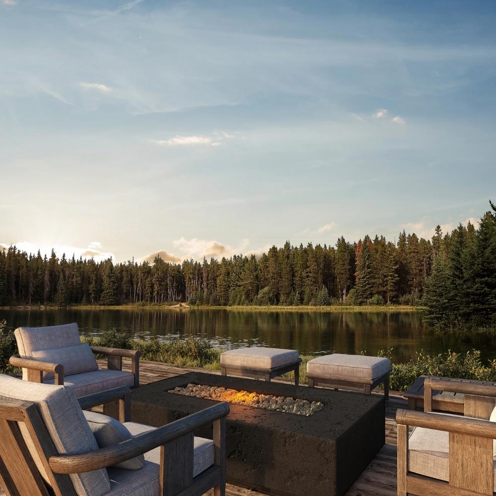 Firegear Sanctuary Rectangular Concrete Gas Fire Pit Table in Raven finish, placed on a lakeside deck with modern outdoor seating.