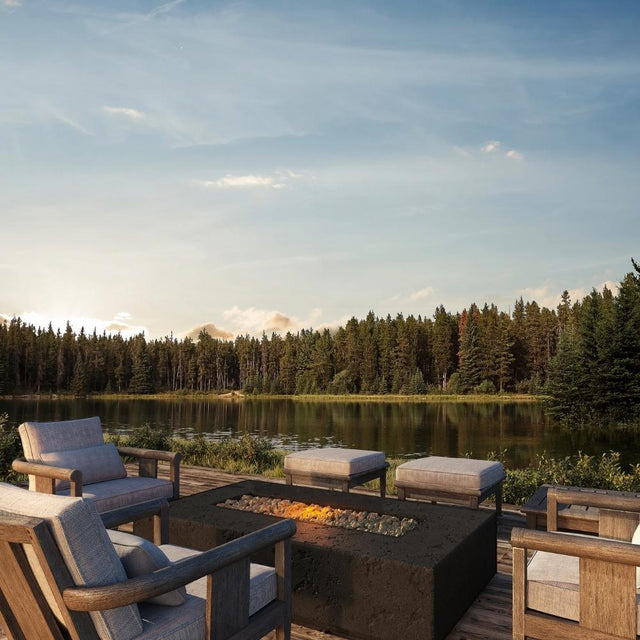 Firegear Sanctuary Rectangular Concrete Gas Fire Pit Table in Raven finish, placed on a lakeside deck with modern outdoor seating.