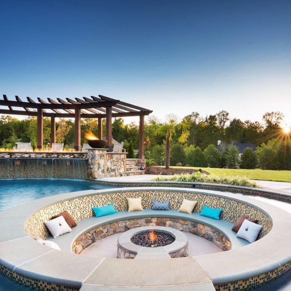 Luxury poolside seating area with Firegear Sanctuary 30-Inch Round Concrete Gas Fire Bowl as centerpiece, ideal for outdoor entertaining.