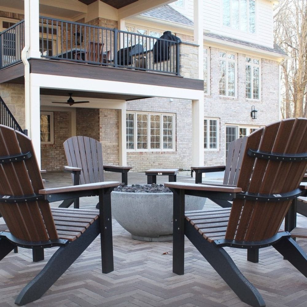 Firegear Sanctuary 39-Inch Round Concrete Gas Fire Bowl in outdoor patio setting with Adirondack chairs, perfect for gatherings.