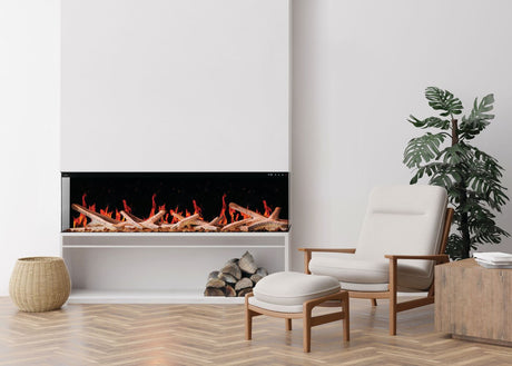 Napoleon Luminex 65 electric fireplace with birch logs and orange flames in a bright living room beside a lounge chair
