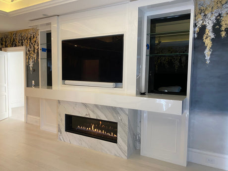 Majestic Echelon II 48 linear direct vent gas fireplace set in a marble surround below a wall mounted TV