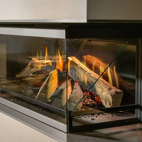 Close-up of NetZero Fire E-One 130B 3D Electric Fireplace - Bay showing lifelike flames and detailed log set behind clear glass panels.