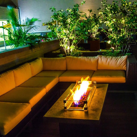 Outdoor fire pit setup using Firegear Pro Series H Burners - Brass Gas Burner, creating a cozy ambiance on a patio with sectional seating.