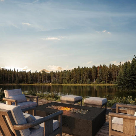 Firegear Sanctuary Rectangular Concrete Gas Fire Pit Table in Raven finish, placed on a lakeside deck with modern outdoor seating.